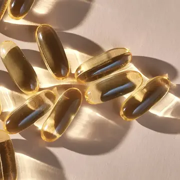 Translucent supplement capsules glistening in the light 